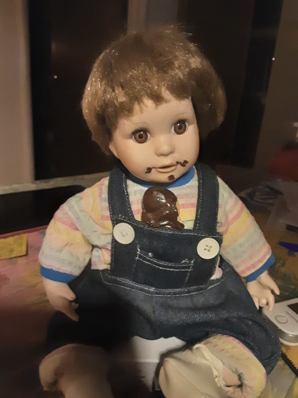 A Child Eating Chocolate Cone Porcelain Doll In Overalls