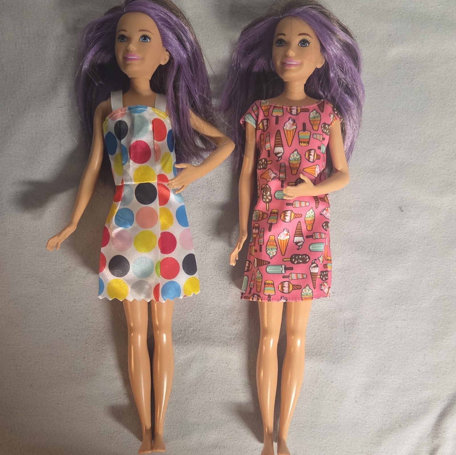 Lot of 2 Skipper dolls w/brown and purple hair blue Eyes, w/dresses