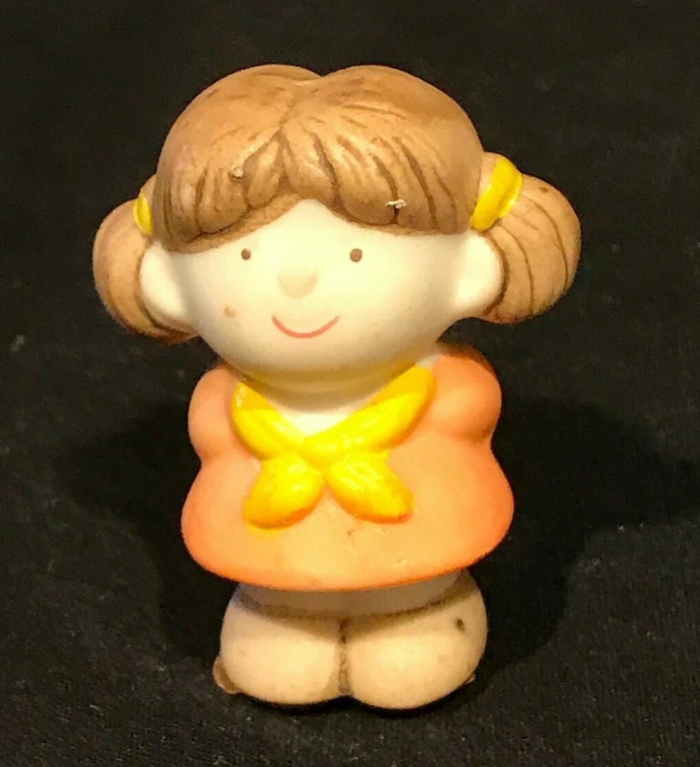 Miniature Little Girl Holding a Heart Behind Her Back Valentine’s Day