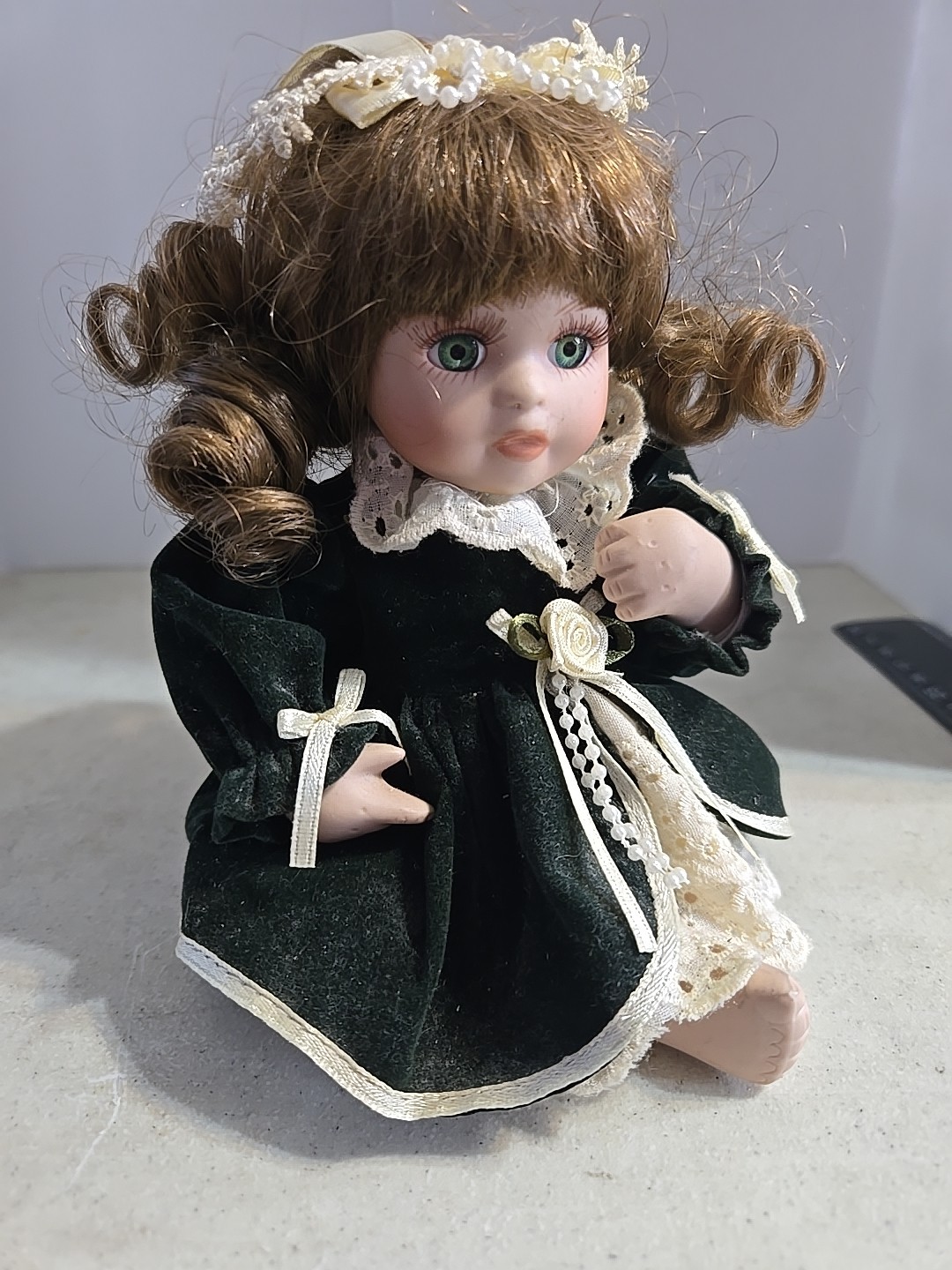 Vintage Porcelain Doll Sitting Wearing Dark Green Velvet Dress 5.5 Inches Tall
