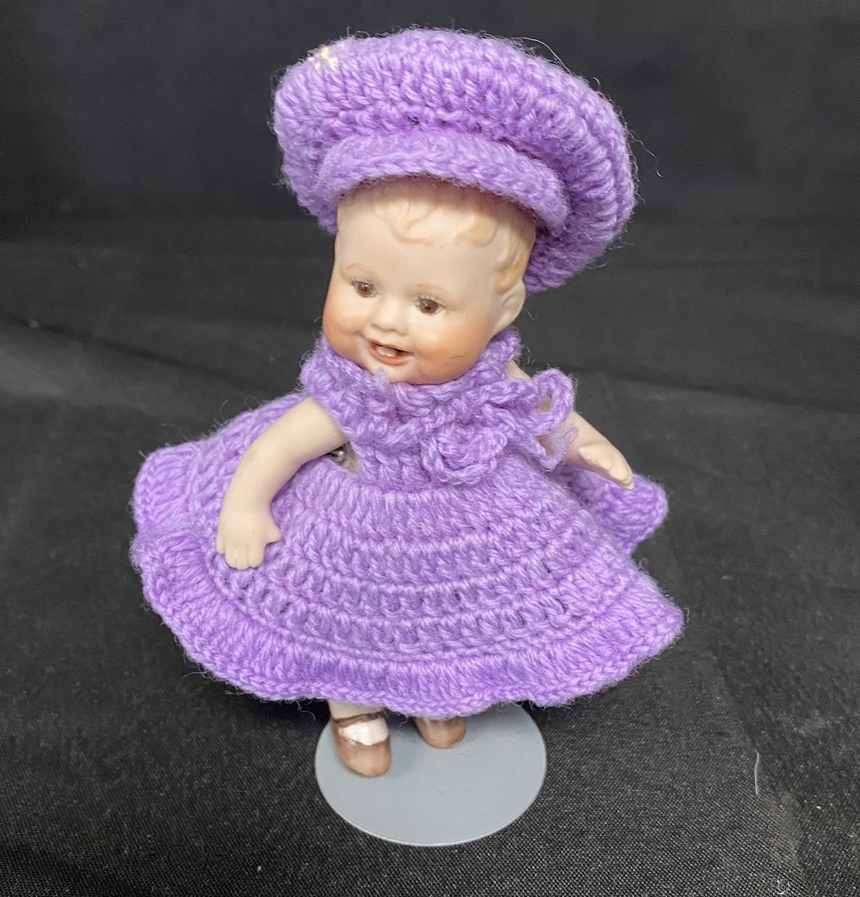 Porcelain Bisque Doll With Purple Crochet Dress & Hat With Stand