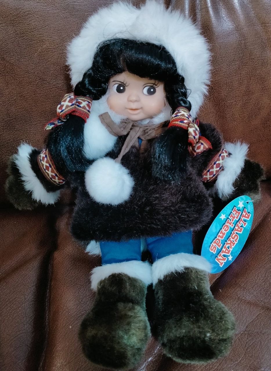 Plastic doll with a sign (Environmentally friendly) With a dense fabric body.
