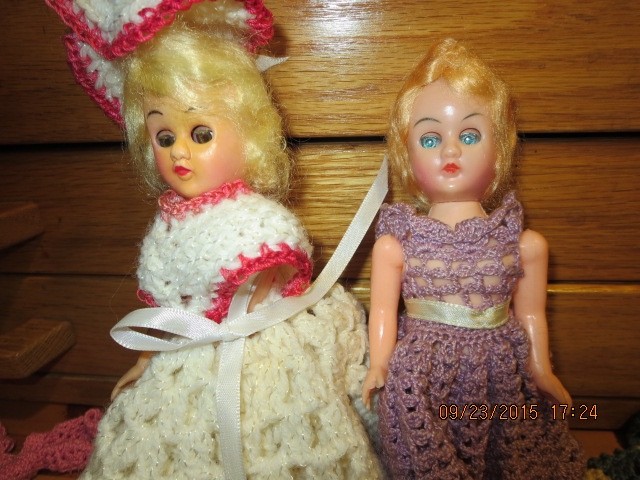 2 VINTAGE 7 1/2″ DOLLS WITH 6 HAND CROCHET DRESSES–#T 4A-7