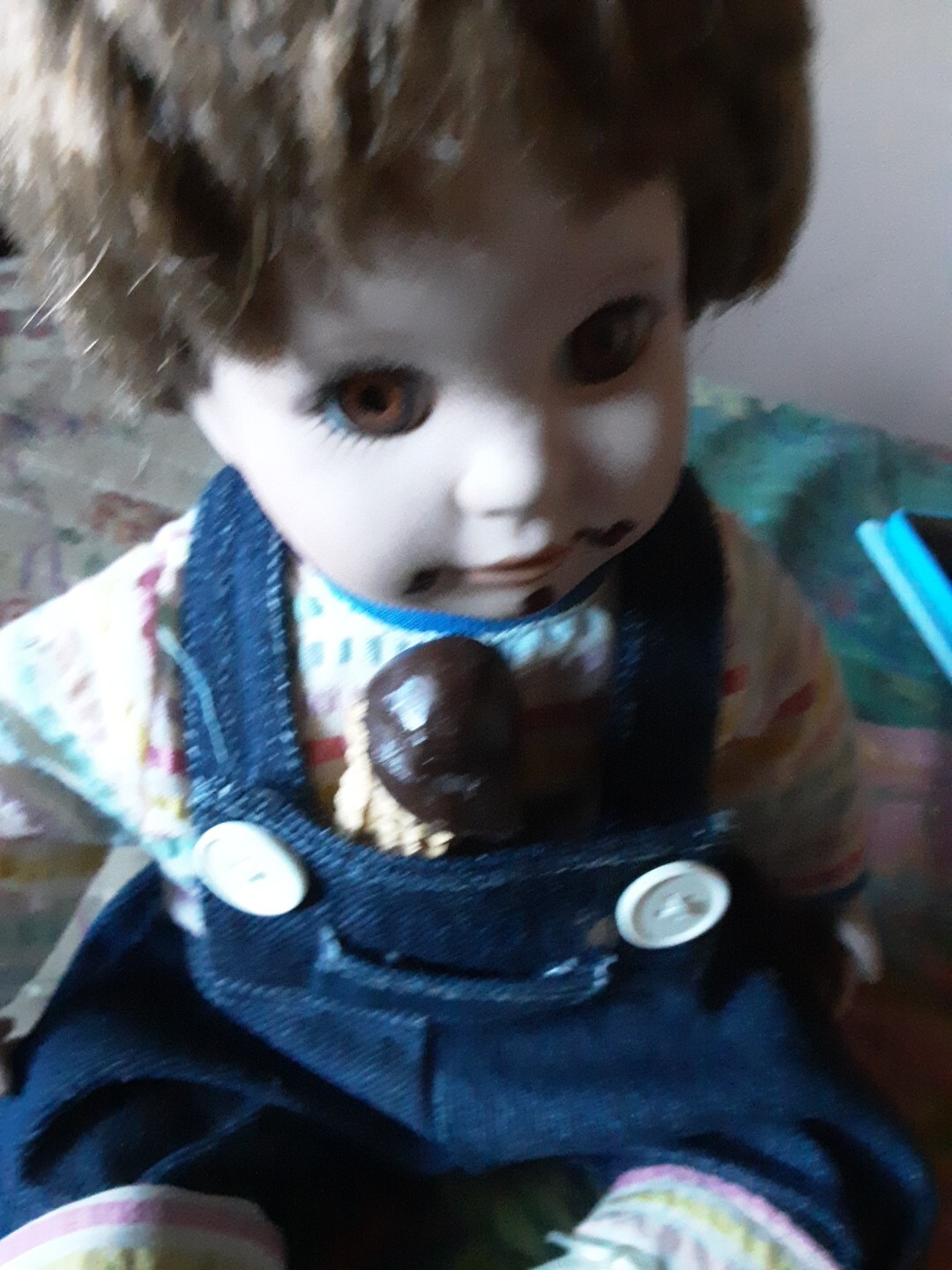 A Child Eating Chocolate Cone Porcelain Doll In Overalls