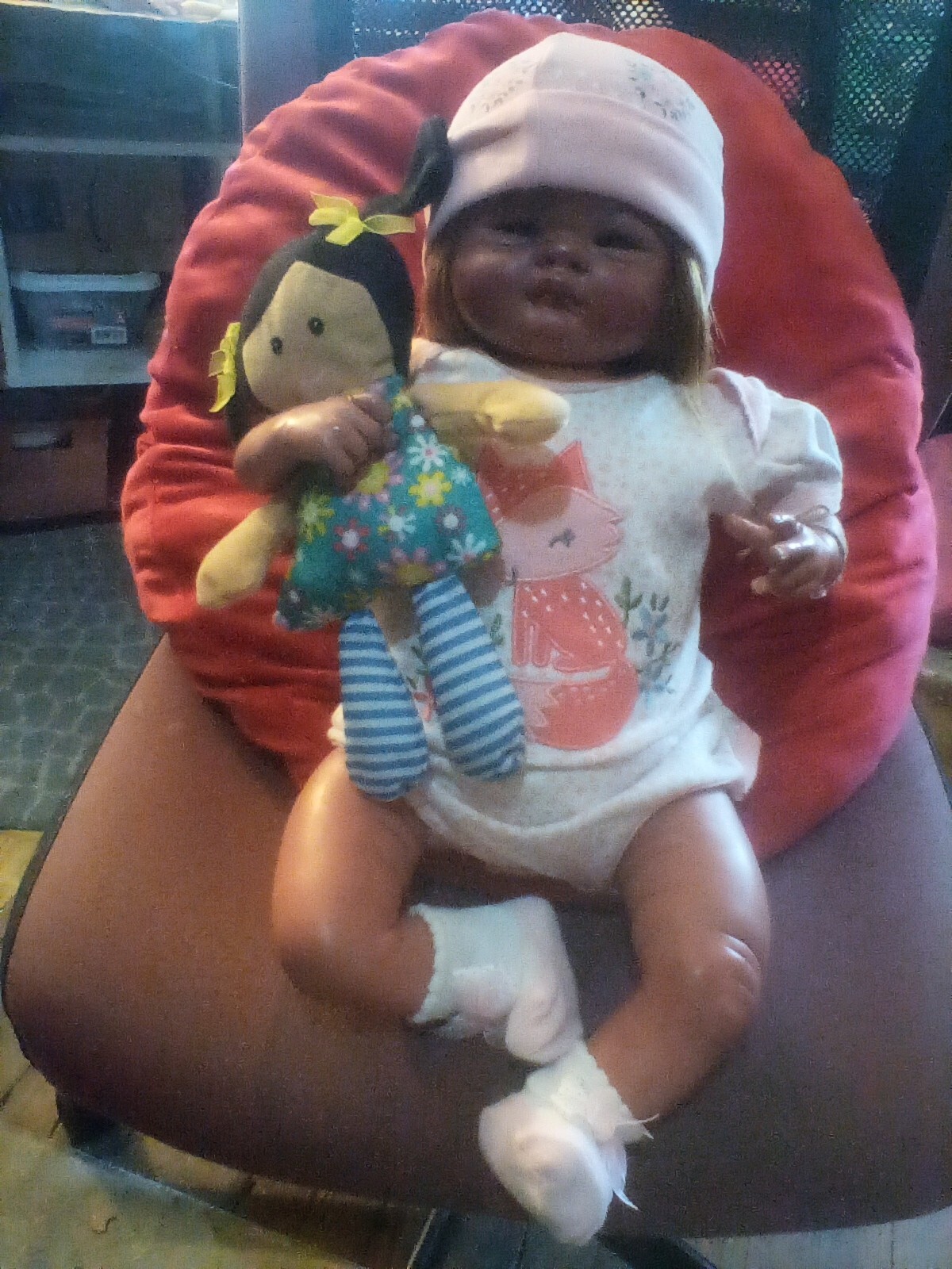 Baby Izzy has open eyes, a full head of brown synthetic hair, and she is heavy.