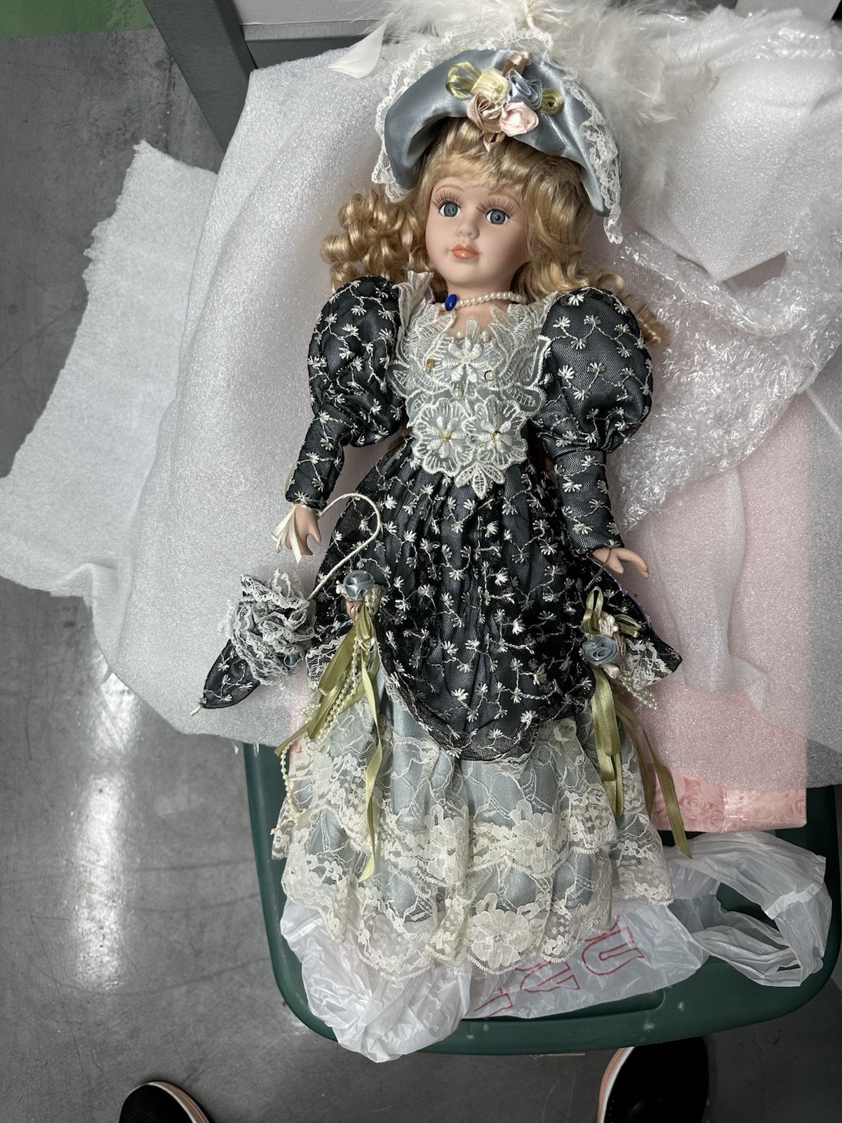 Porcelain doll with hat, parasol and outfit