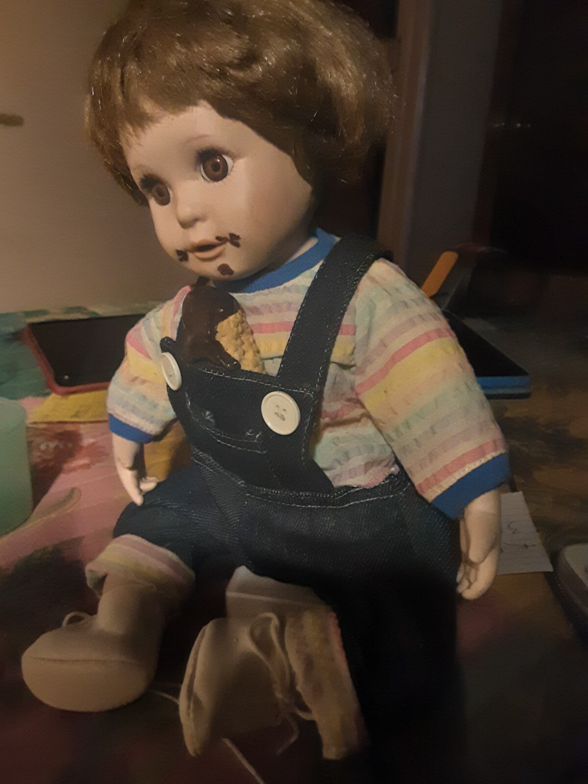 A Child Eating Chocolate Cone Porcelain Doll In Overalls