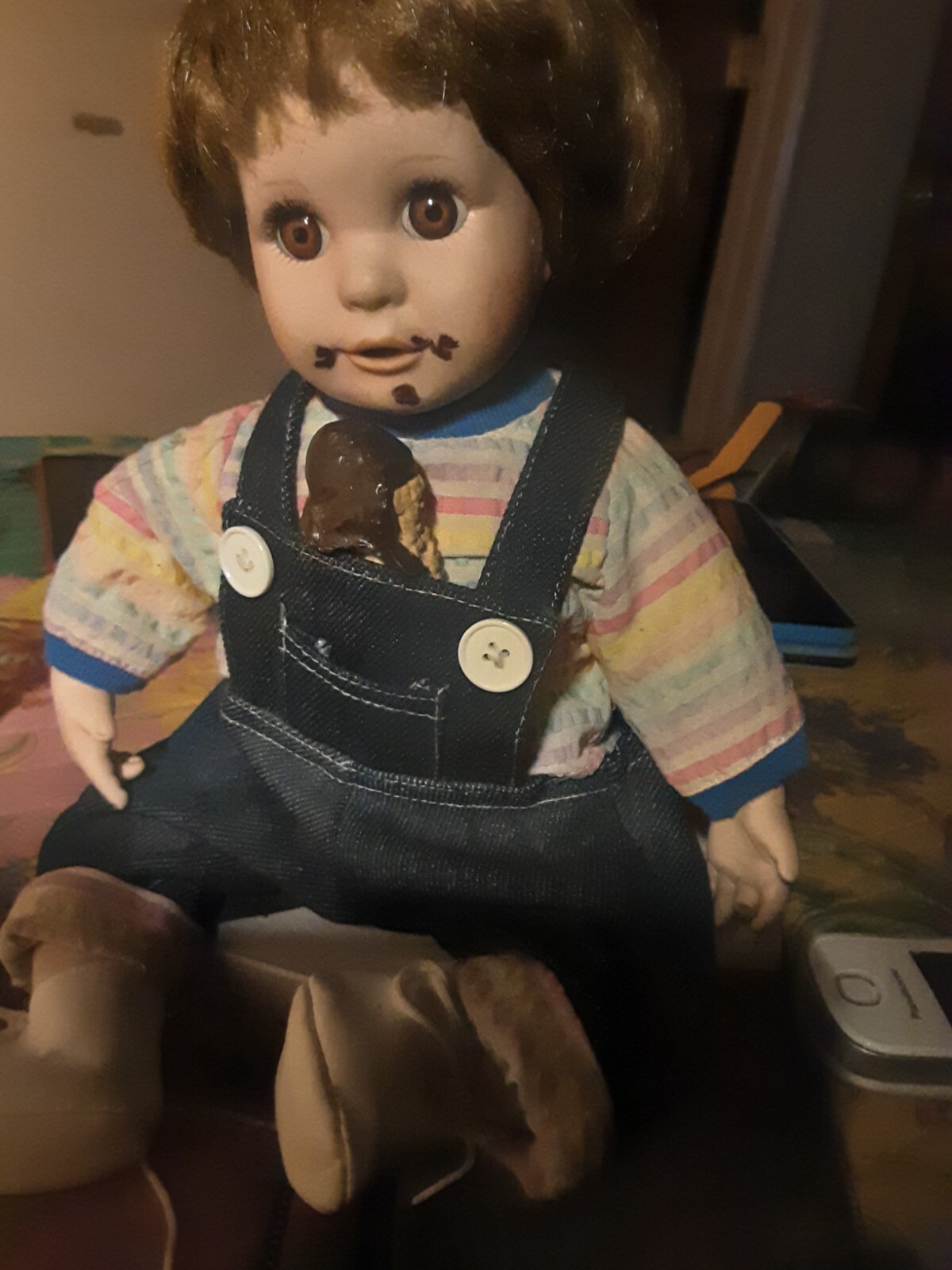 A Child Eating Chocolate Cone Porcelain Doll In Overalls