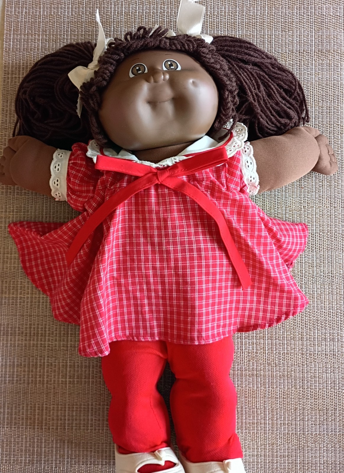 Cabbage Patch Kids dark skinned girl doll w/pigtails. Includes original box.